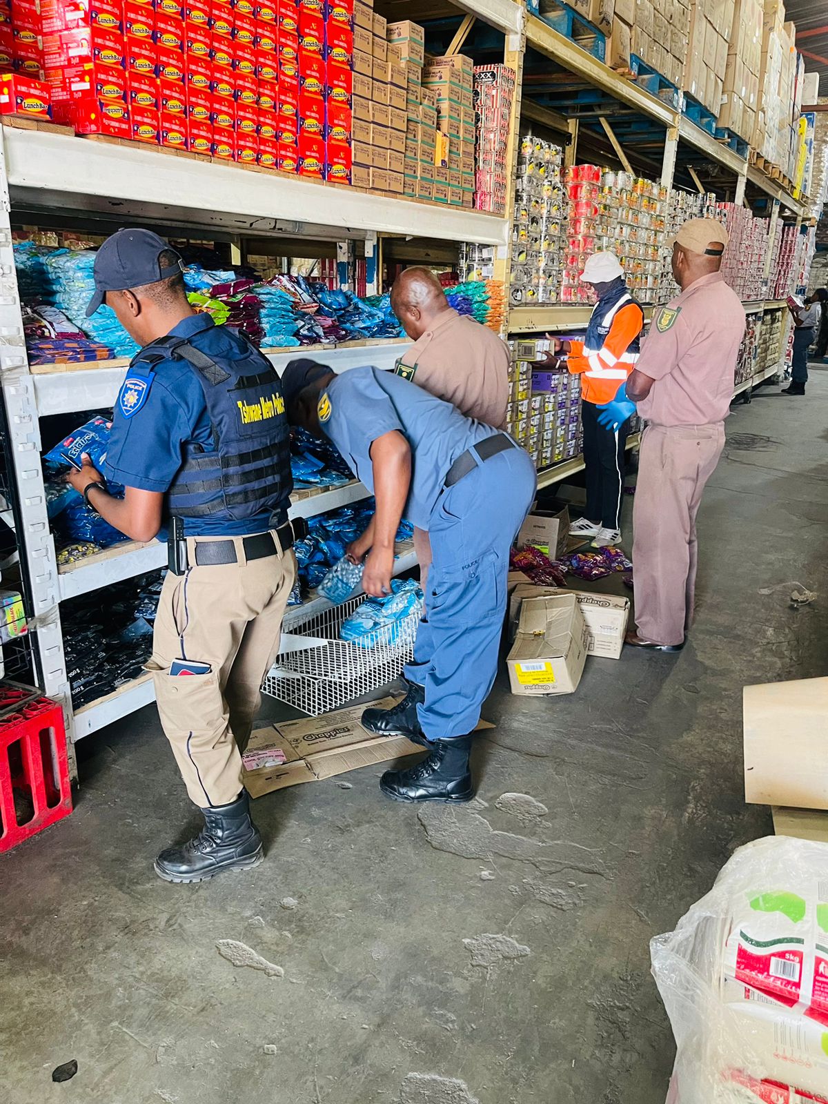 Law enforcement at one of the spaza shop in Temba, Hammanskraal, Tshwane inspecting food.