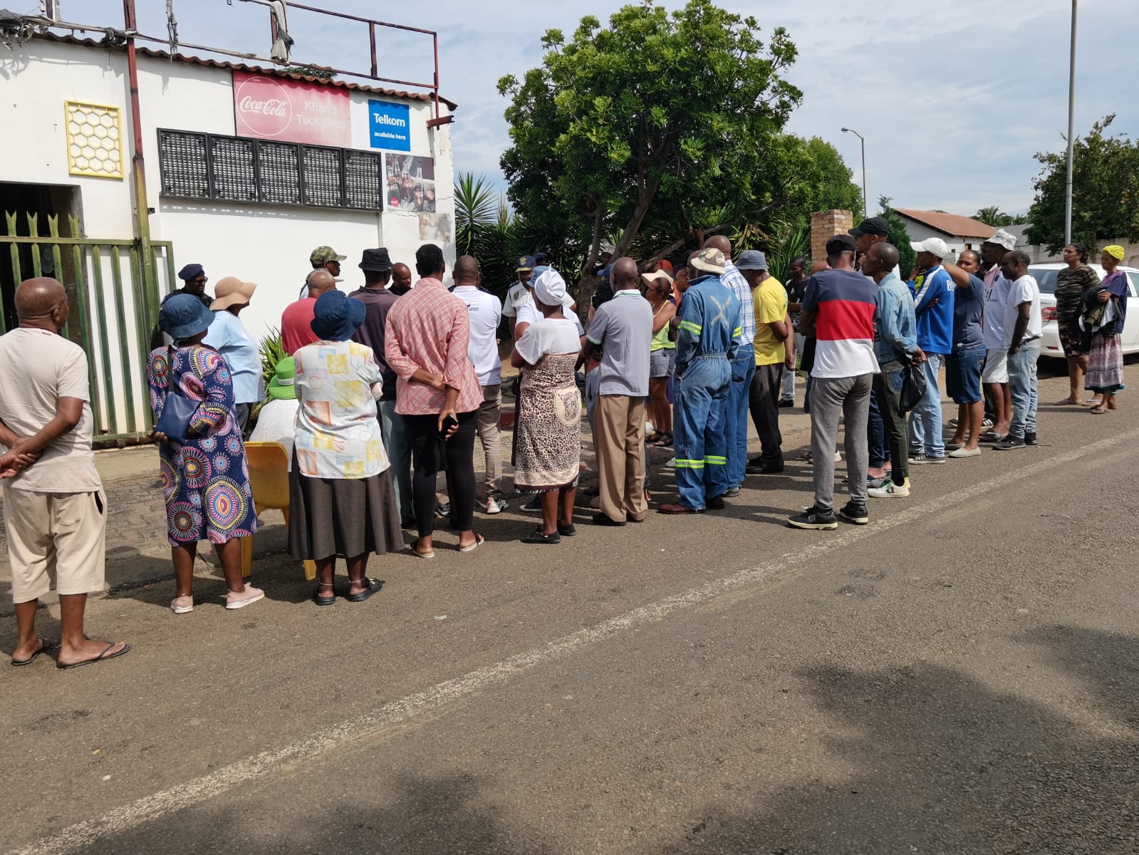 Residents of Lotus Gardens standing outside one of the spaza shop that sells expired food