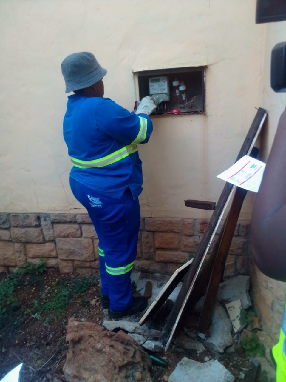 Municipal officials cutting off electricity from meter box of one of the properties that are in arrears photo by Peter Mothiba