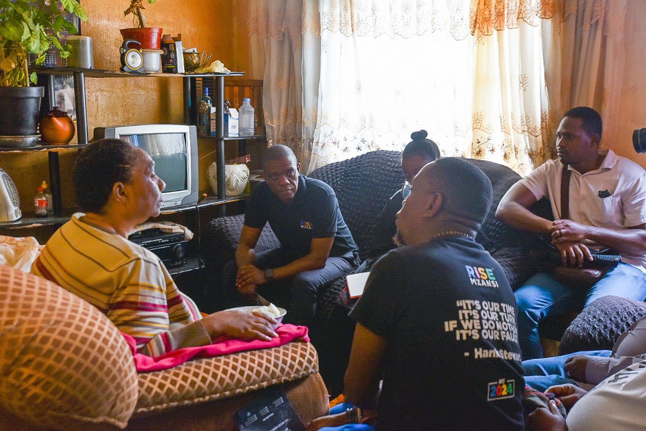 Rise Mzansi leader Songezo Zibi in conversation with a lady tenant who lives in a shack in Atteridgeville