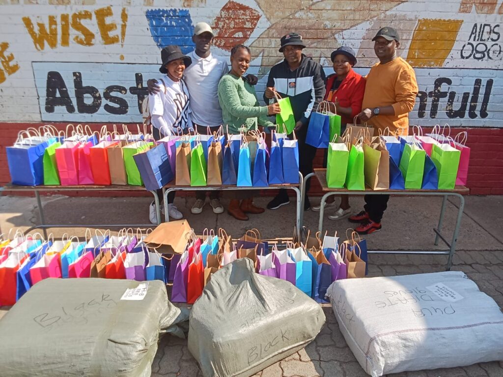 Umkkhumbi Place of Safety and Children's Home and Ibandla Lika Kristu church hands out winter clothes to Principal of Pula Difate primary school Mavis Mahlobogoane photo by Dimakatso Modipa