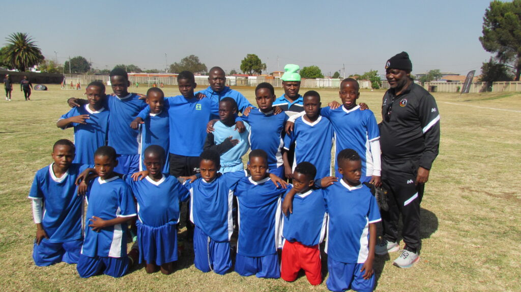 Young boys from AS Savannah football club with coach Pitso Mosimane photo by Dimakatso Modipa