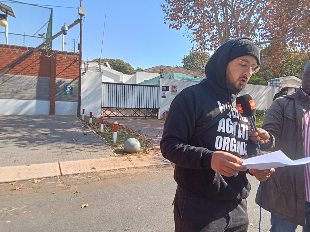 Coordinator of STOPEACOP Campaign in South Africa Zaki Mamdoo reading a memorandum outside Chinese embassy in Pretoria photo by Dimakatso Modipa