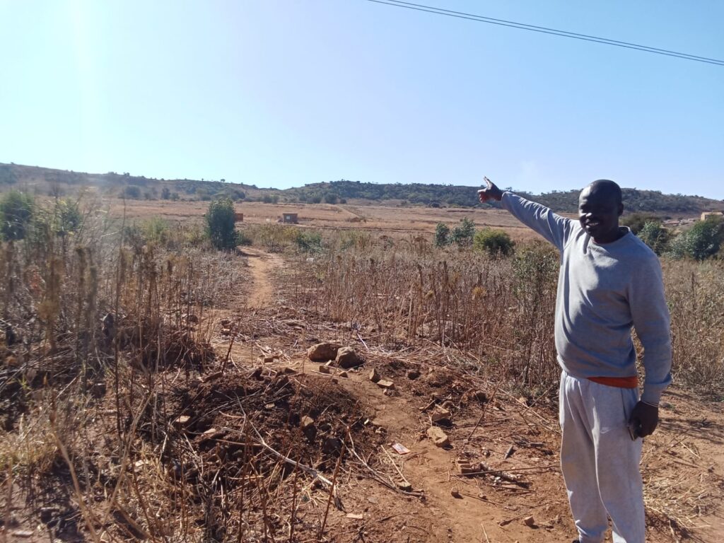 Member of the Residents Community Governance (RCG) Alfred Khazamola standing on an empty land in Danville, Tshwane photo by Dimakatso Modipa