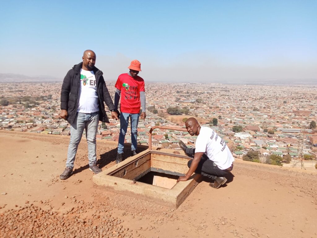 EFF subregion leader Bongani Ramontja with some EFF fighter at the reservoir with no lid photo by Dimakatso Modipa