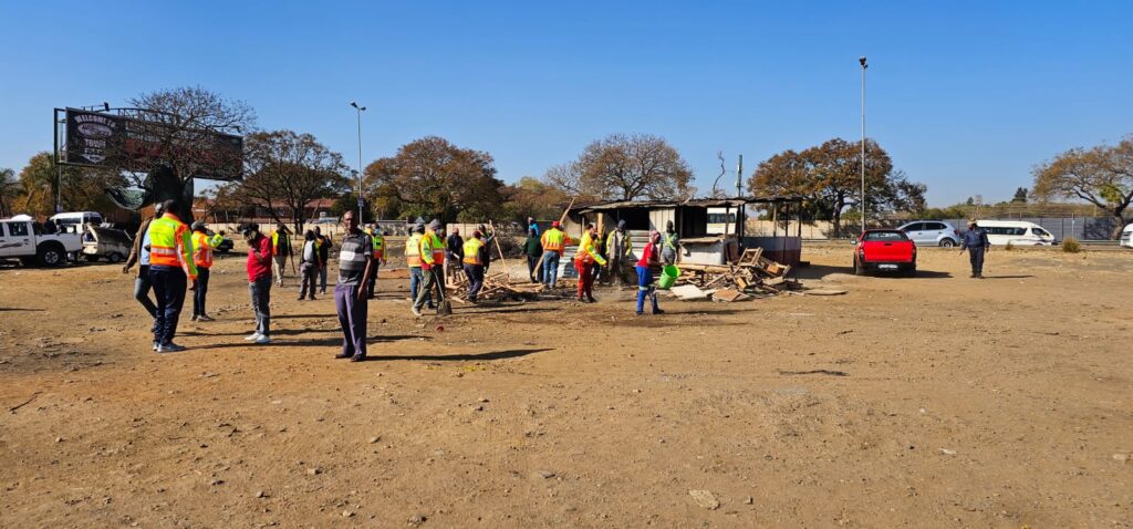 Mamelodi Local and Long-Distance Taxi Association (MALLDTA) chairperson Stemmer Monageng and members on a cleaning up campaign in East lynne 