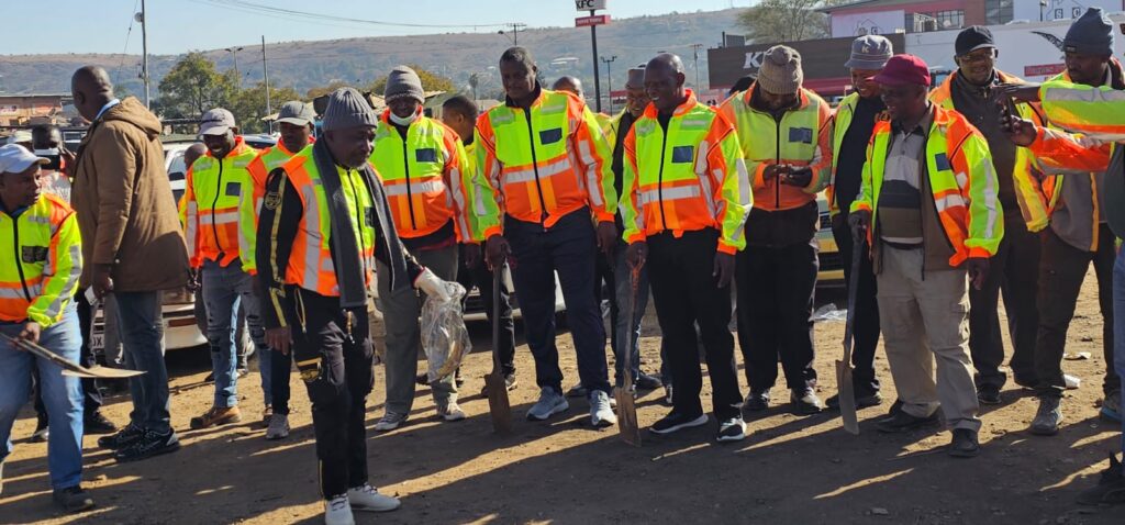 "Mamelodi Local and Long-Distance Taxi Association (MALLDTA) chairperson Stemmer Monageng and members on a cleaning up campaign in East lynne