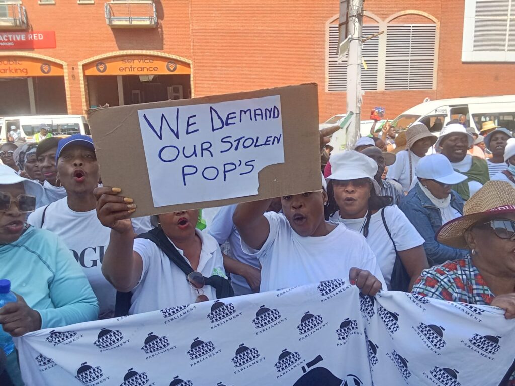 Tshwane residents holding placard at Tshwane House