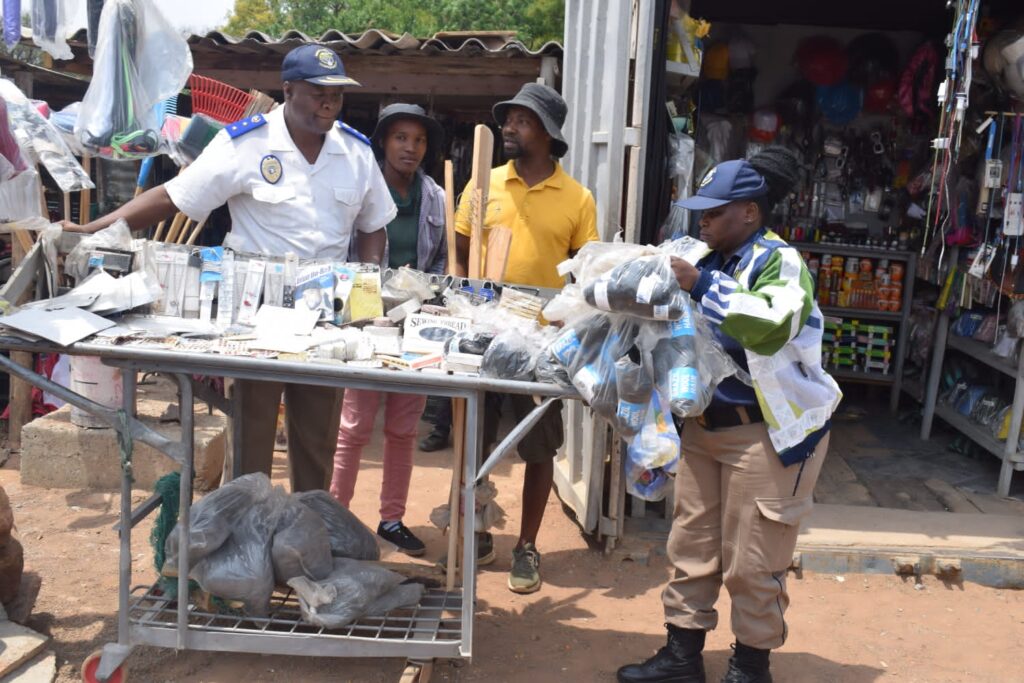 TMPD officials confiscating illegal goods