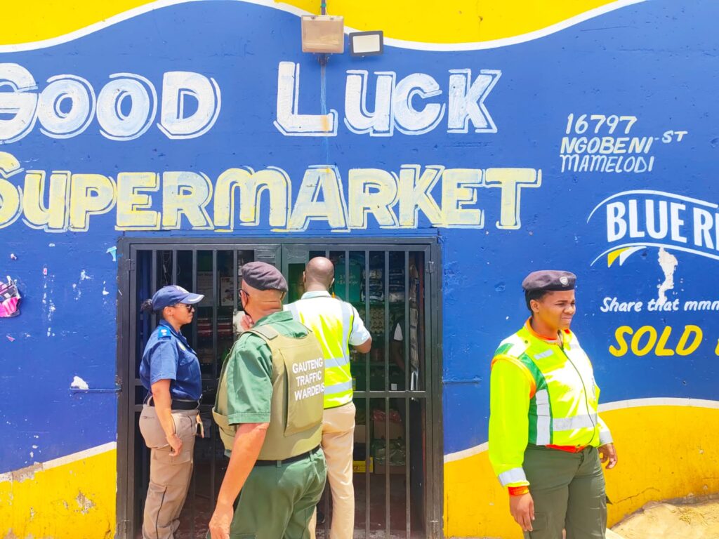 Law enforcement outside the foreign tuck shop owner in Mamelodi