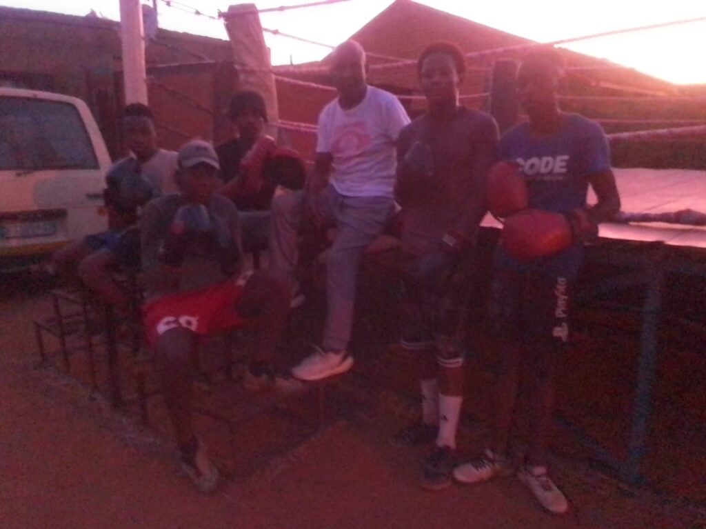 Boxing trainer Jan Mabetha Mathole with the boys that he trains photo by Peter Mothiba