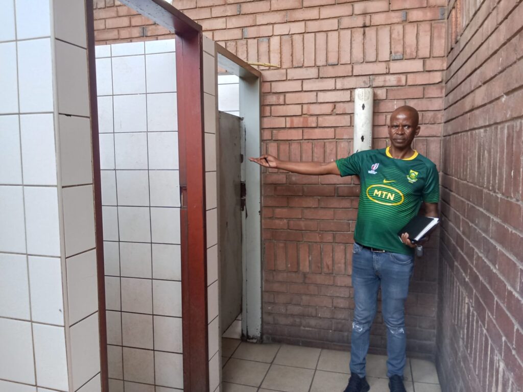 Pretoria United Long-Distance Taxi Association (PULDTA) Public Relations Officer (PRO) Groot Sithole showing toilets that have stopped working from 2021 