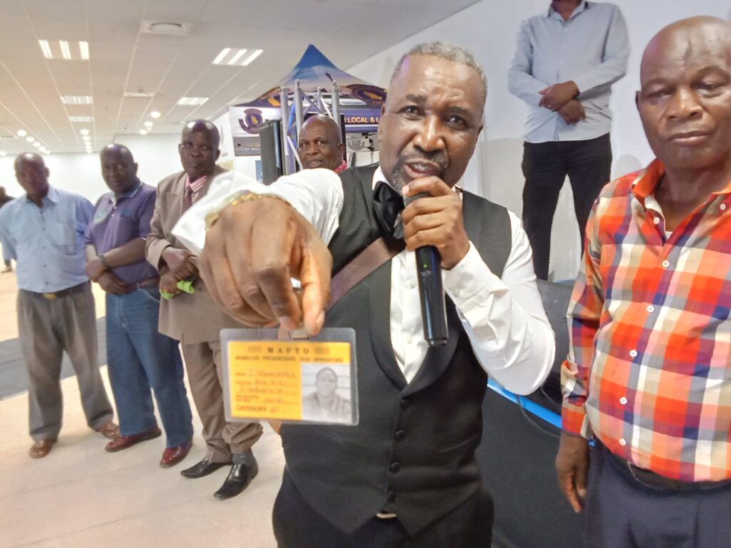 Mamelodi Local and Long-Distance Taxi Association (MALLDTA) chairperson Stemmer Monageng showing an old membership card of association 