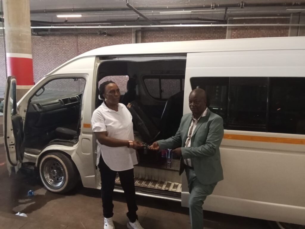 Widow Shierly Moabelo wife of former late chairperson Lazarus Moabelo, standing next to new quantum with PRO Mpho Mukhari 