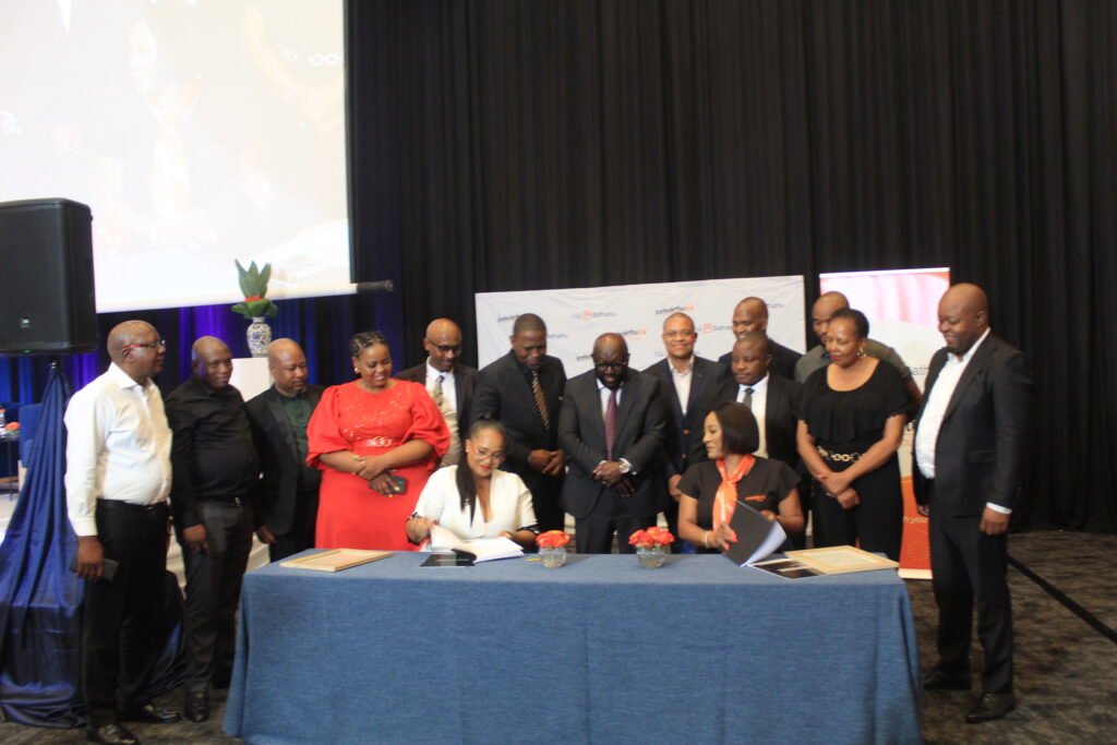 Bathathu Funeral Scheme CEO Ayanda Williams and Icebolethu Group CEO Dr Nomfundo Mcogi sign a share certificate photo by Dimakatso Modipa