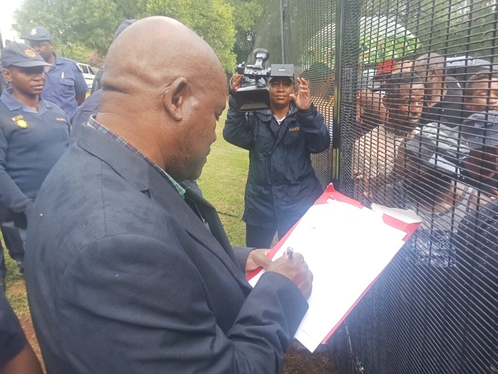 Philemon Mahlangu sign a copy memorandum 