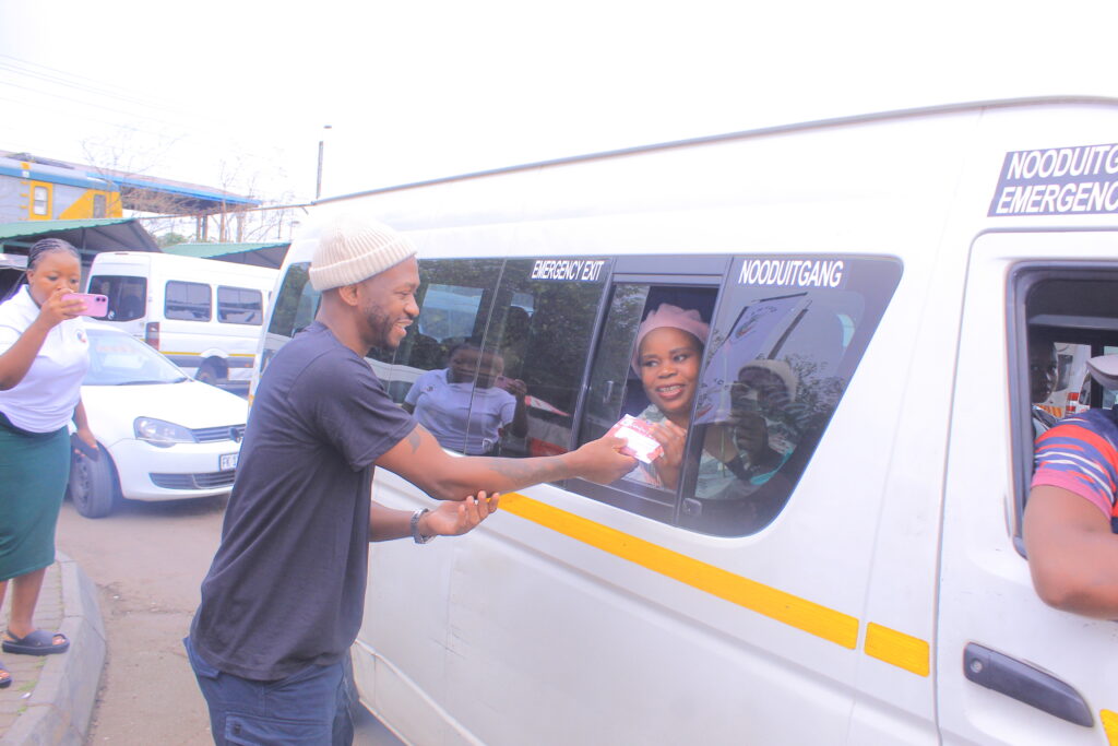 SANTACO member hands out flower and chocolate to passengers