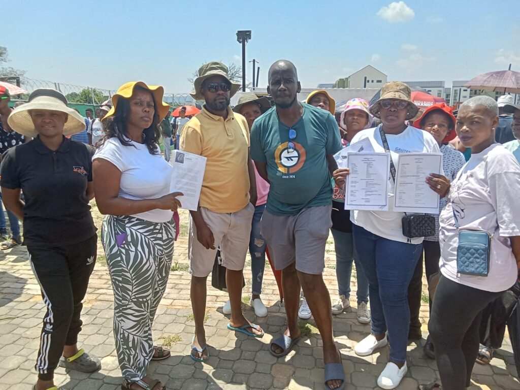 City of Tshwane chairperson of Section 79 Committee chair on economic development and Spatial planning and Ward 15 Councillor Joel Masilela with community members fight for jobs at Balwin construction site photo by Dimakatso Modipa