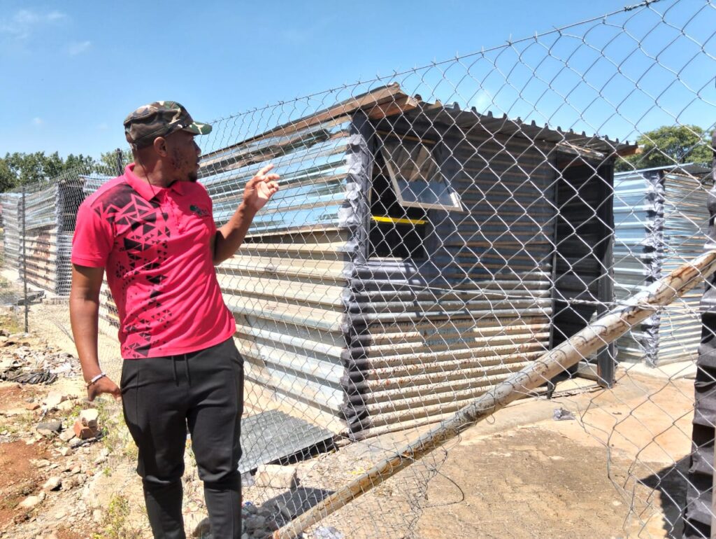 Salvakop Ward 80 EFF activist Nare Lemao standing next to the shacks at relocation site in Salvakop 