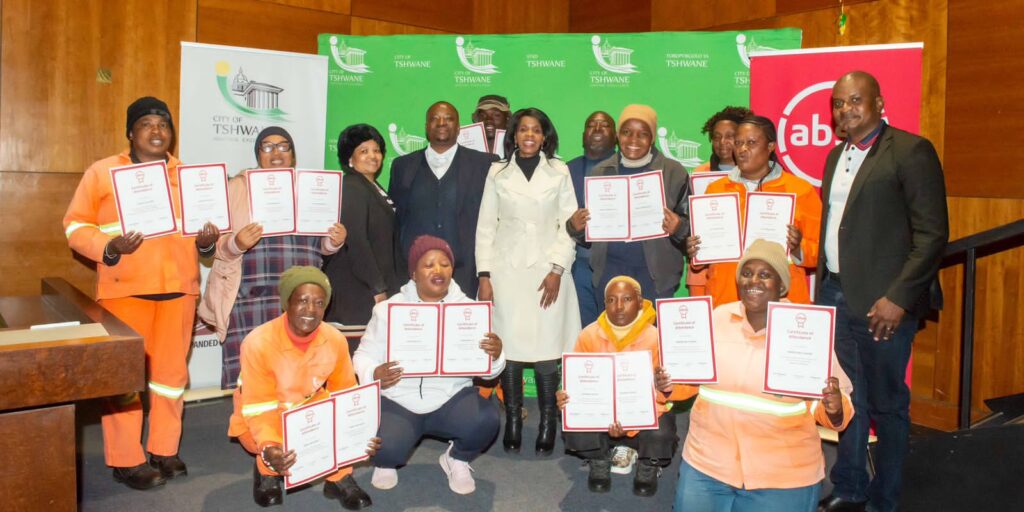 ABSA’s Team Leader of External Sales, Mr. Khudisi Makhaga joined by Councillor Sarah Mabotsa,  MMC for  Economic Development and Spatial Planning, with some of the participants of PEP and EPWP