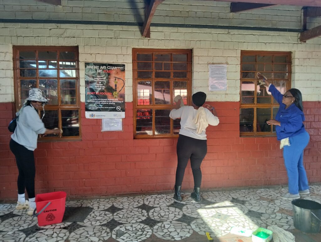 Parents of Balebogeng primary school clean windows photo by Dimakatso Modipa