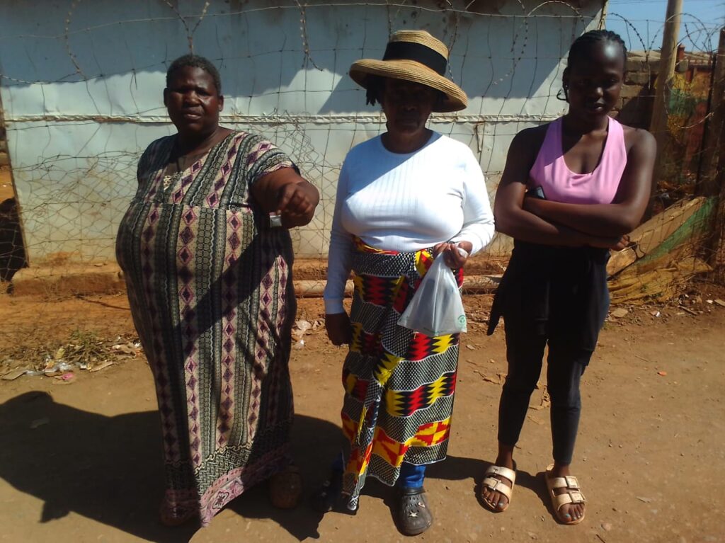 Residents of Phomolong Khomotso Maphoto, Maria Mahlangu and Mahlatsi Maphoto holding packets of Aldicarb ( Galephirimi) which they found in their yard photo by Peter Mothiba