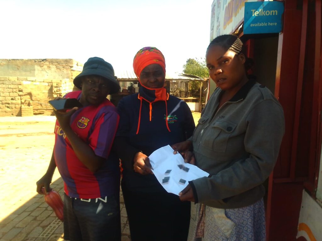 Another group of Phomolong residents Mr Ramoncha, Johanna Senyane and Precious Mongadi holding packets of Aldicarb ( Galephirimi) photo by Peter Mothiba