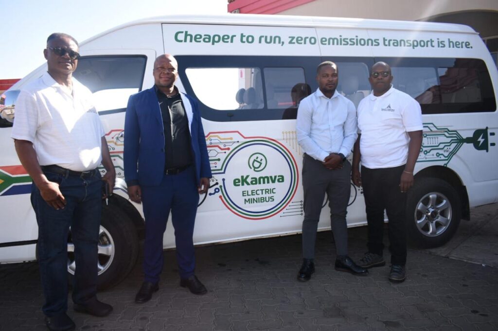 Officials and taxi association standing next to an electric Mini Bus Taxi