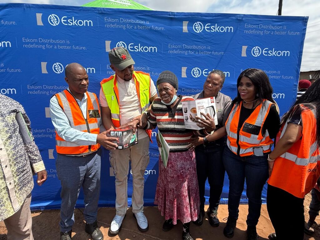 MMC Maluleka, flanked MMC Boshielo handing out electricity appliance to an elderly lady resident of De Wagendrift photo supplied 