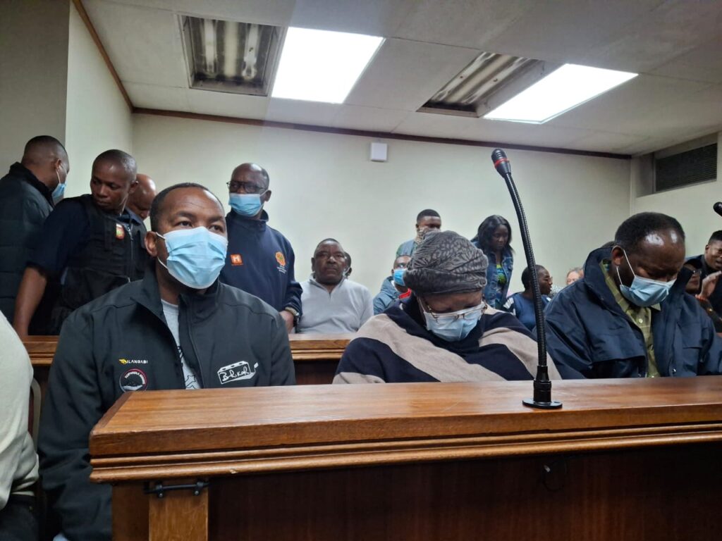 Four accused persons, a leader of the International Pentecost Holiness Church Bhekumuzi Mike Sandlana (64), a Judge of the High Court of South Africa, Gauteng Division, Pretoria Judge, Portia Phahlane (57), her son Kagiso Phahlane (32) and Vusi Soli Ndala