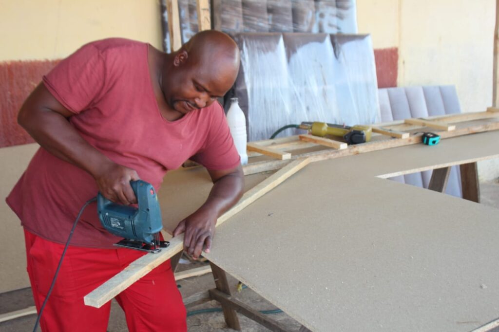 Victor Machaba, Founder and Director of IMD Upholstery, at work.
