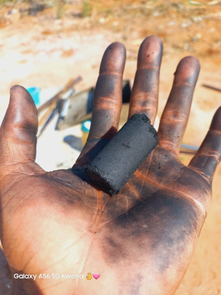 Ngwepe holds self-made charcoal produced from maize cobs