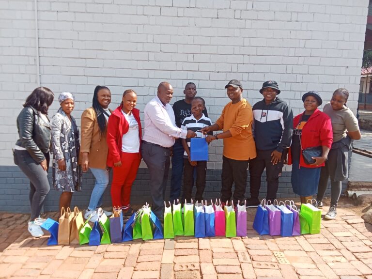 Umkkhunbi Place of Safety and Children's Home and Ibandla Lika Kristu church hands out winter clothes to Principal of Zaminthuthuko Primary School Makoti Maisela photo by Dimakatso Modipa