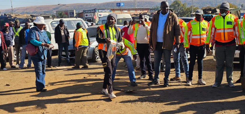 Mamelodi Local and Long-Distance Taxi Association (MALLDTA) chairperson Stemmer Monageng and members on a cleaning up campaign in East lynne