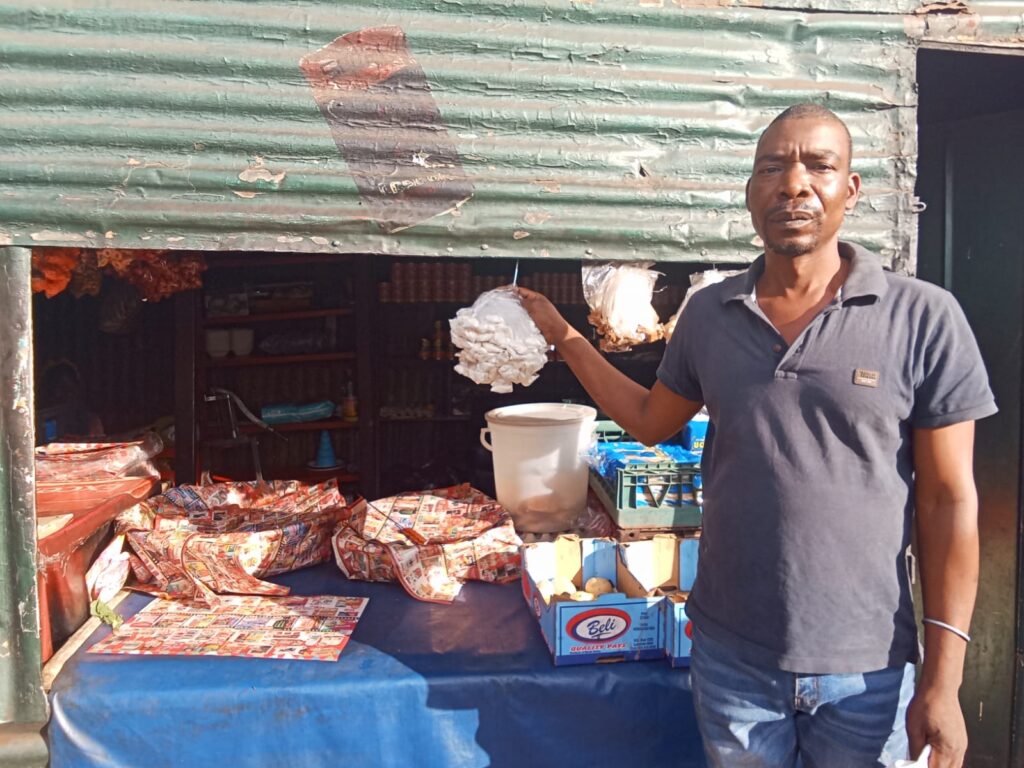 Orlando Chauke standing next to his shop in Mamelodi West Hostel photo by Dimakatso Modipa