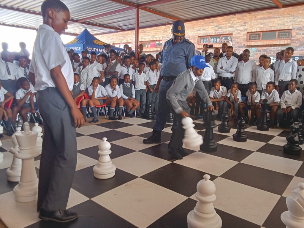 Gauteng Police Commissioner Lieutenant General Tommy Mthombeni playing chess with learners at Agnes Chidi primary school in Mamelodi photo by Dimakatso Modipa