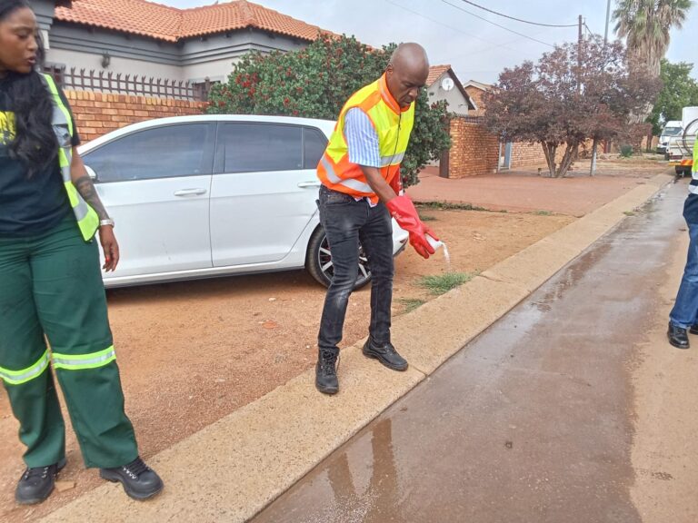 City of Tshwane Deputy Mayor Eugene Modise helped clean the sewage blockage in Mamelodi photo by Dimakatso Modipa