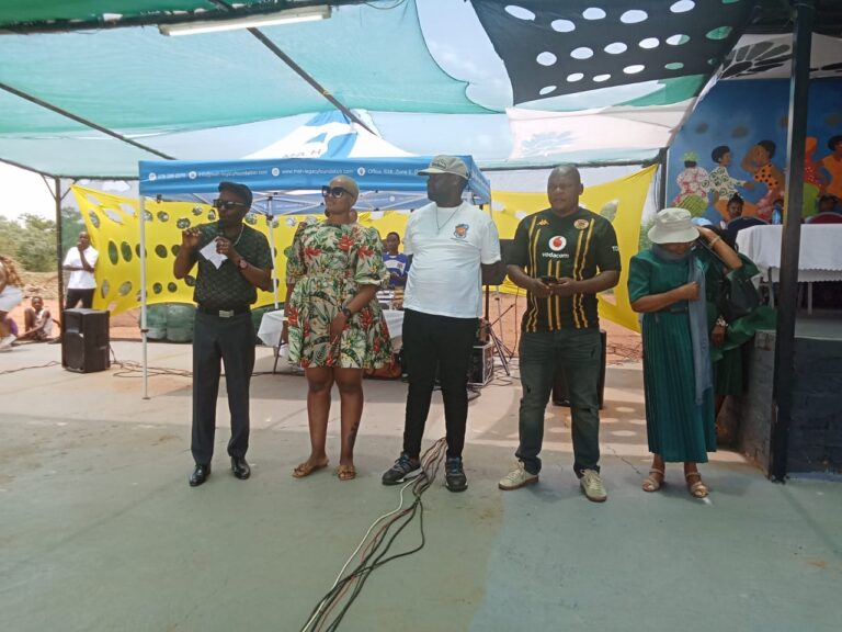 Rama City committee chairperson Mpho Nthite with the families who received houses photo by Dimakatso Modipa
