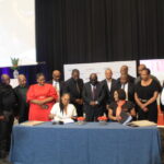 Bathathu Funeral Scheme CEO Ayanda Williams and Icebolethu Group CEO Dr Nomfundo Mcogi sign a share certificate photo by Dimakatso Modipa