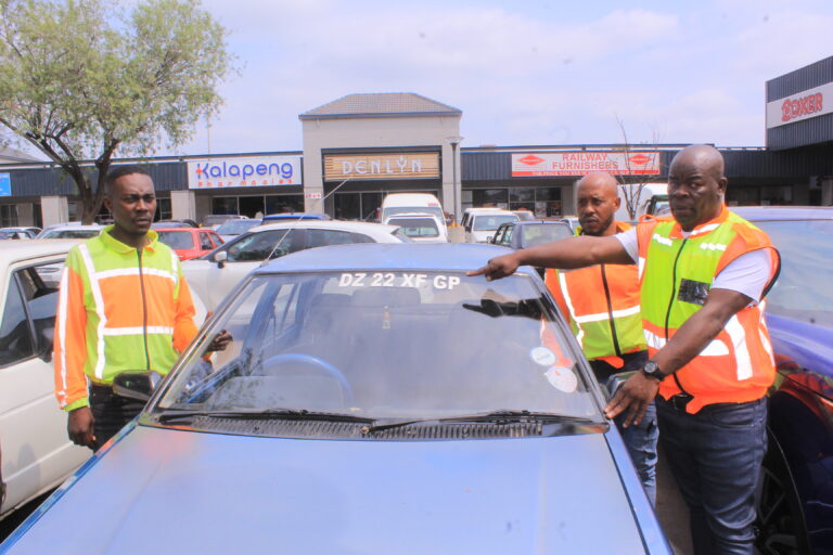 4 Plus 1 taxi association monitoring team in front Nathaniel Sparks Thulare, (back) Motlatso Snake Matloga and Karabo Makitla showing 4 plus 1 taxi stickers. photo by Dimakatso Modipa
