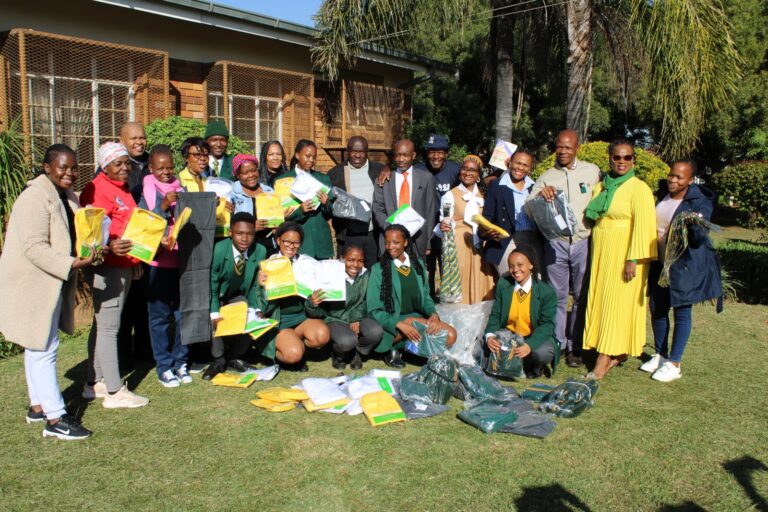 The Lehlabile Secondary School alumni (former learners) and learners and teacher donating school uniform