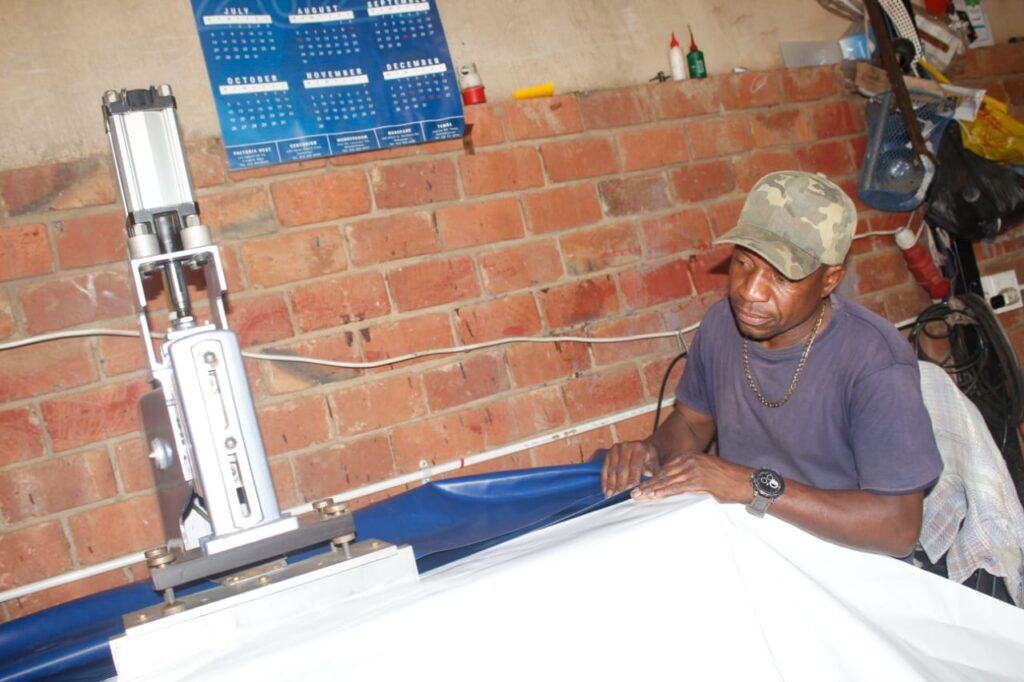 Peter Sithole of McLean Trading and Projects on top of what he knows best: tent manufacturing